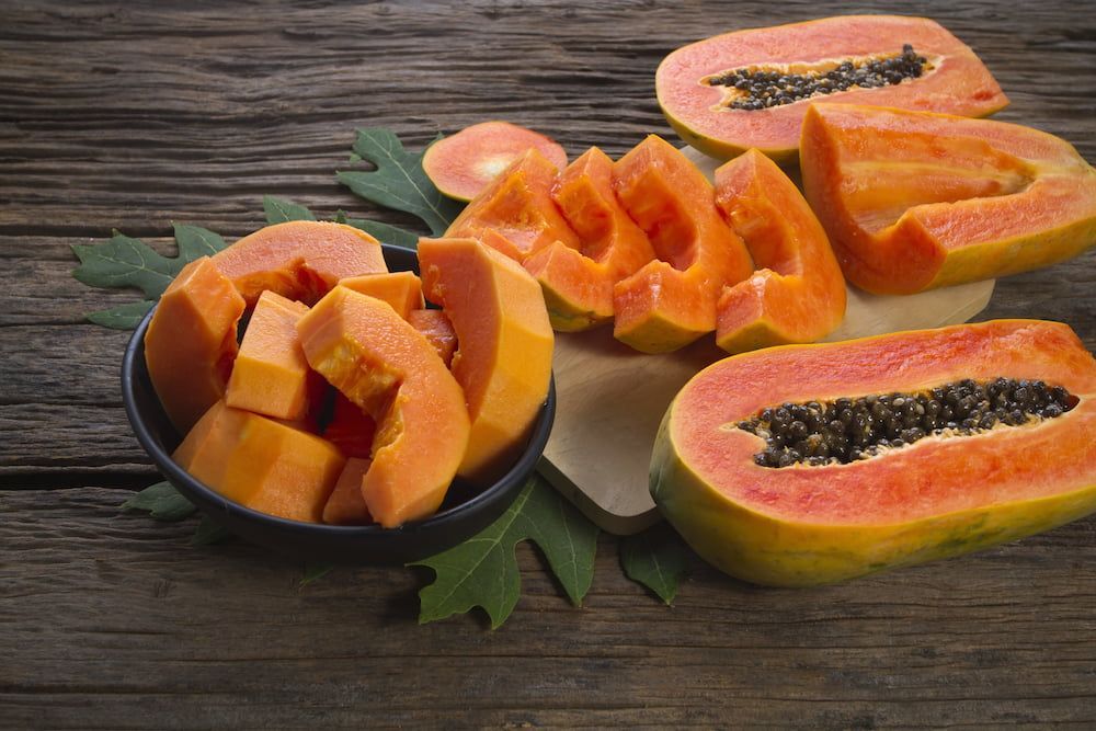 A Bowl of Sliced Papaya on a Wooden Table — Mareeba Golden Dried Mangoes in Townsville, QLD