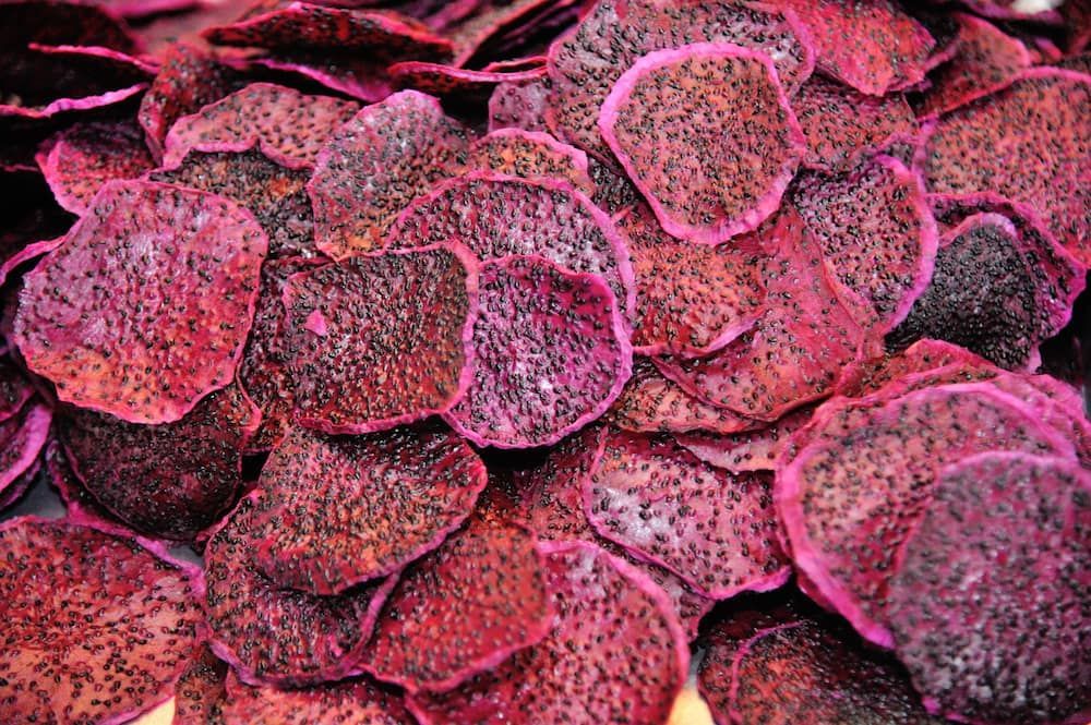 A Bowl of Dried Dragon Fruit Chips on a Wooden Table — Mareeba Golden Dried Mangoes in Townsville, QLD