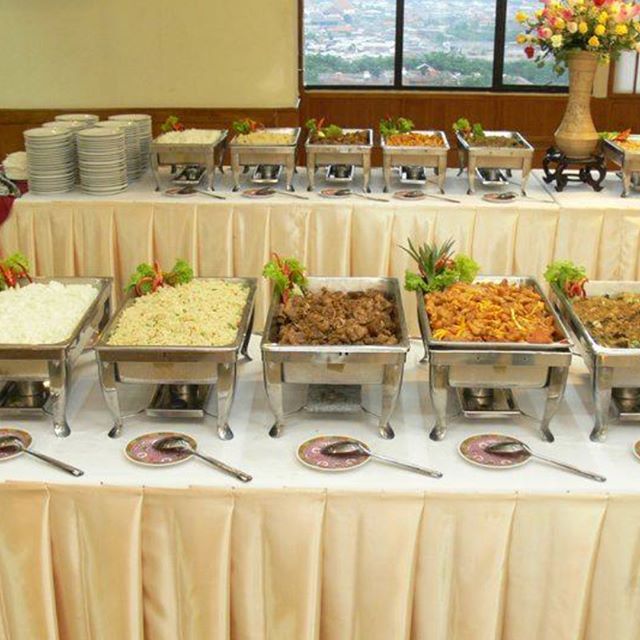 A buffet table with many different types of food on it