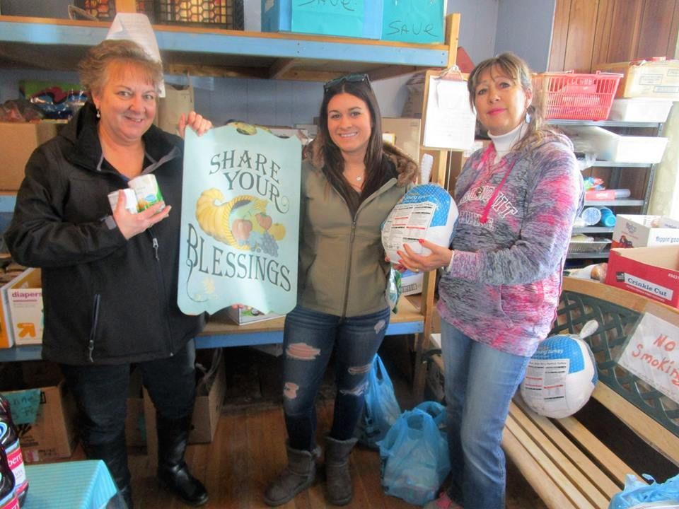 Three women holding a sign that says share your blessings