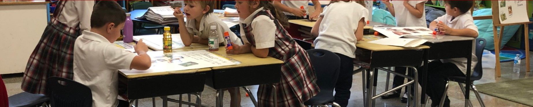 A group of children are sitting at desks in a classroom.