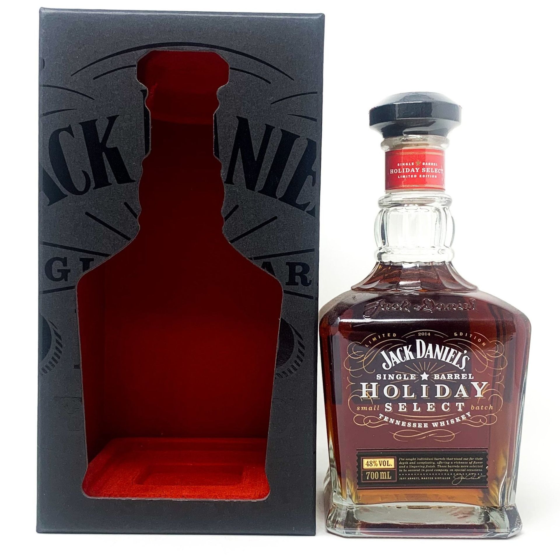 A bottle of jack daniels holiday select next to its box