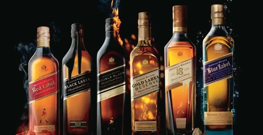 A row of bottles of johnnie walker whiskey are lined up in a row.