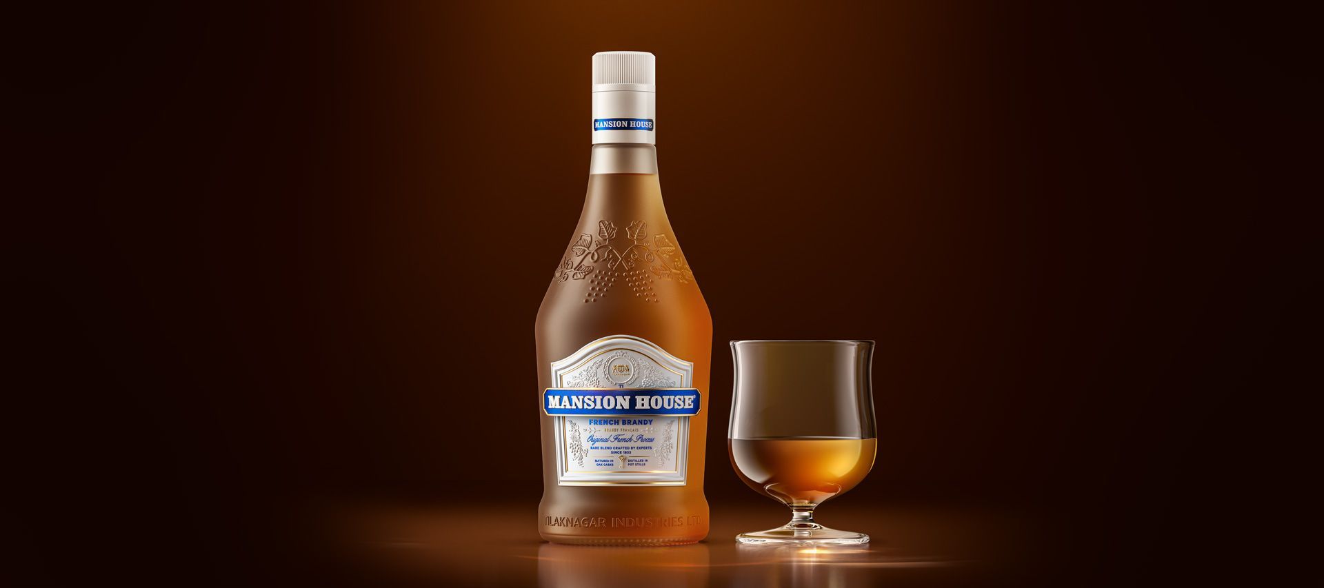 Bottle of liquor and glass with liquor on a brown background.