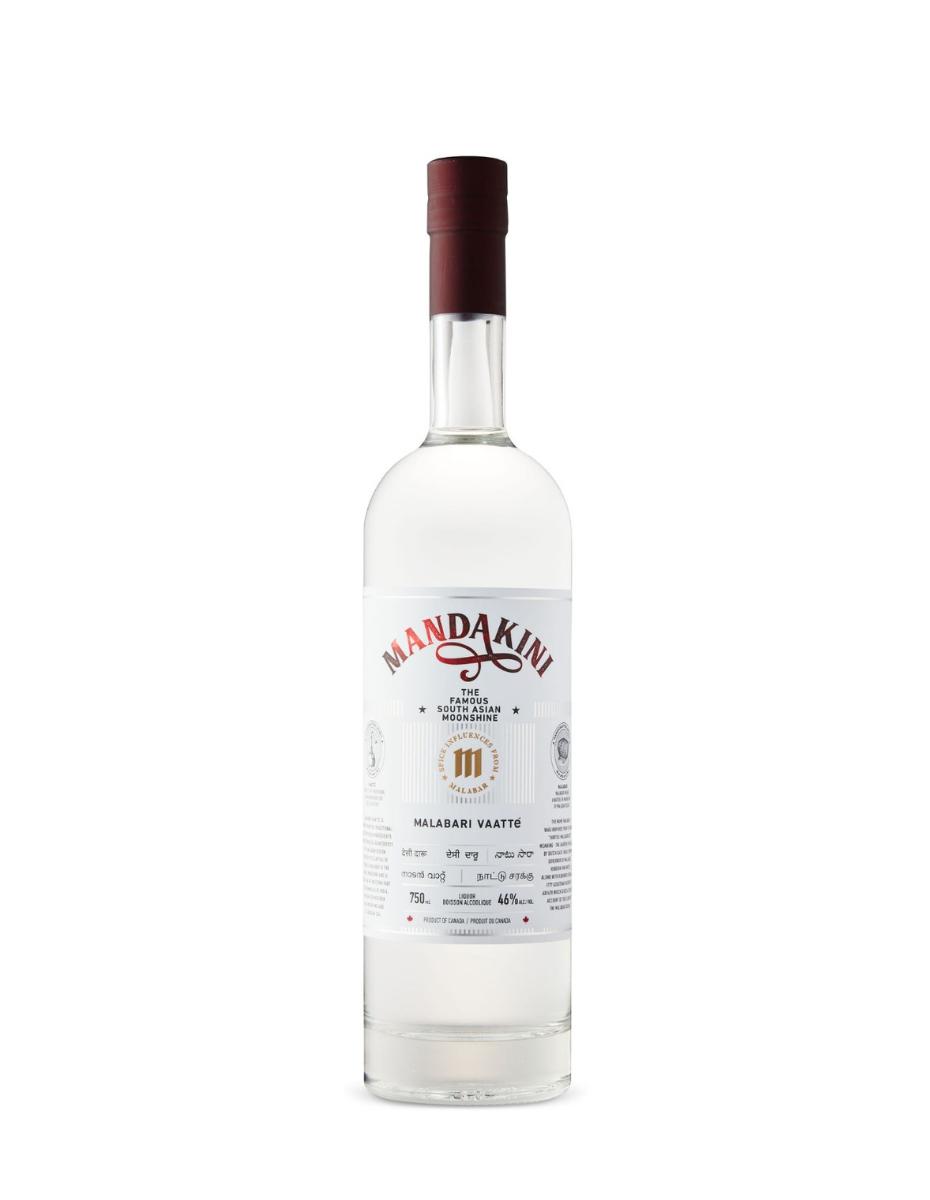 A tall, clear glass bottle of Mandakini spirit with a white label, dark red cap, and clear liquid, isolated on white.