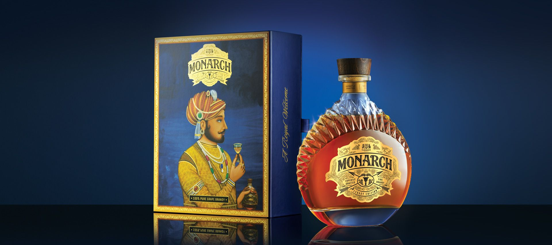 Whiskey bottle and box with a portrait of a regal figure. Blue and gold color scheme.