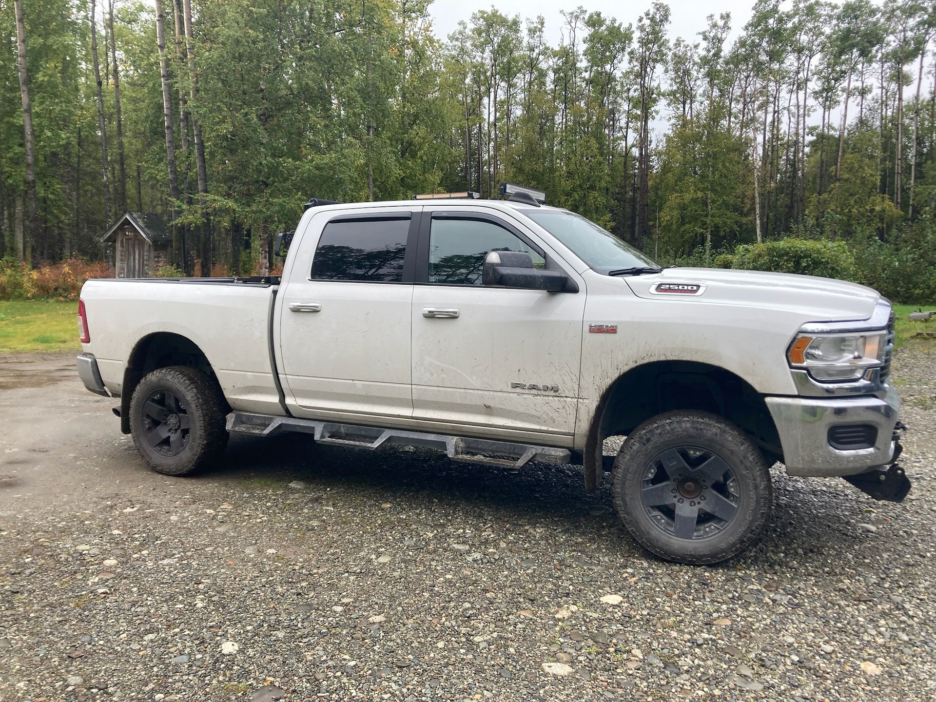 White Pickup Truck Parked On Gravel Road Near Trees | Hatch Peak Motorworks