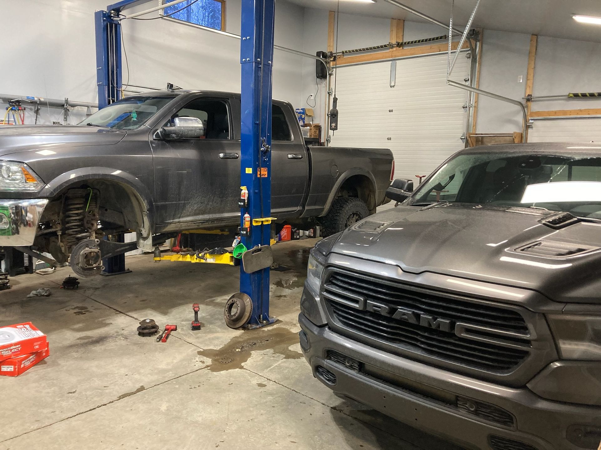 Gray Pickup Truck Lifted On Hydraulic Hoist For Wheel And Brake Service Inside Garage | Hatch Peak Motorworks