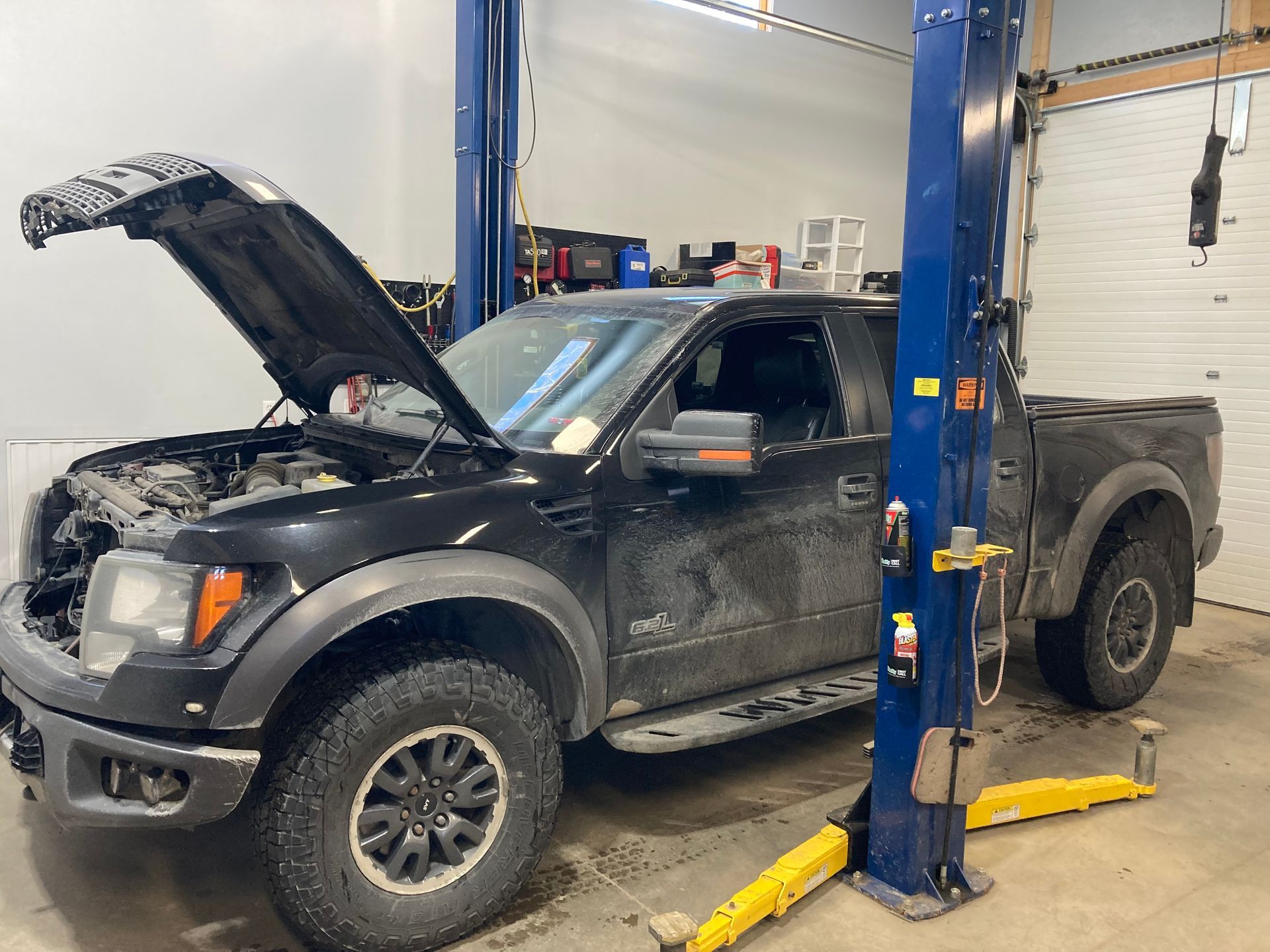 Black Pickup Truck Lifted For Engine Repair Inside Shop | Hatch Peak Motorworks