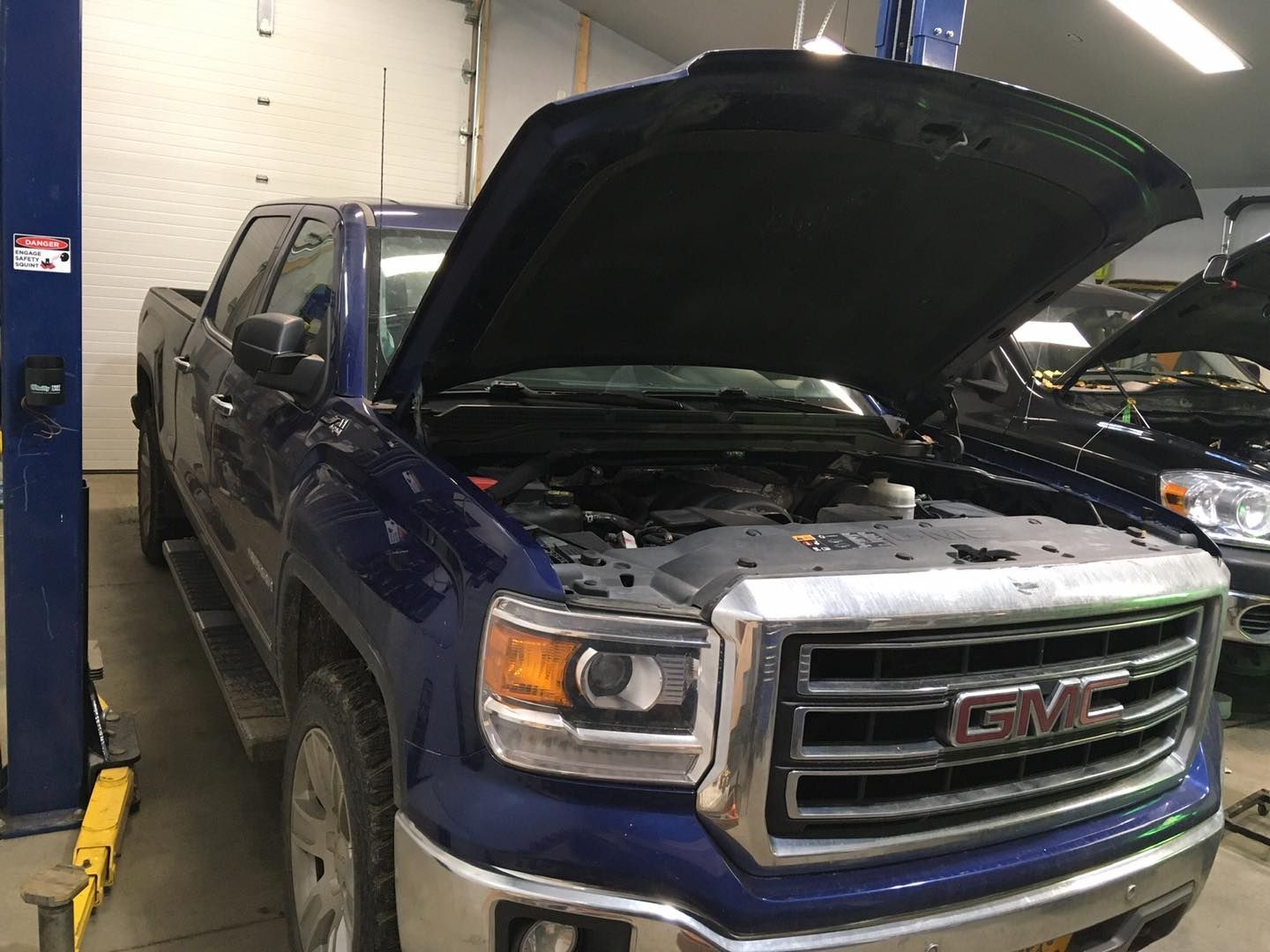 Blue GMC Truck With Hood Raised For Engine Inspection | Hatch Peak Motorworks