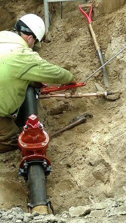 A Crew Fixing a Pipeline — Paving Services in Nashua, NH