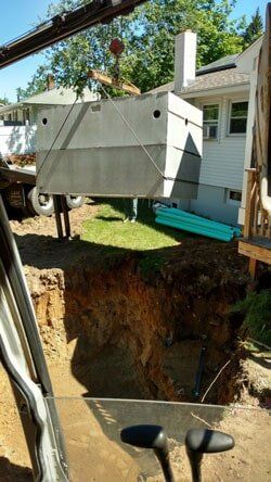 A Block of Cement Being Carried by a Machine — Paving Services in Nashua, NH