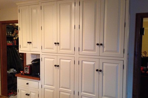 White kitchen cabinets with black knobs.