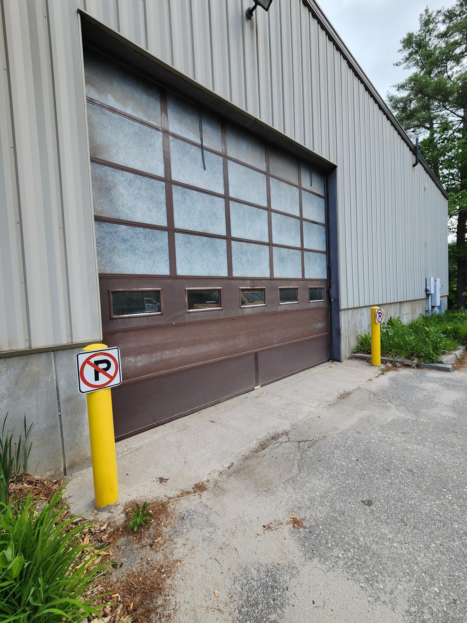 A garage door with a no parking sign next to it.