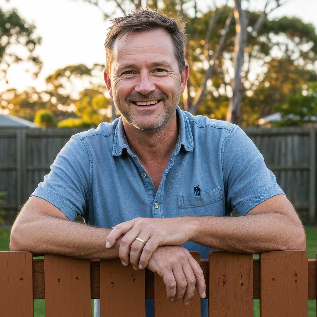 Proud Homeowner Posing with Fresh Paintwork by Gladstone Painters