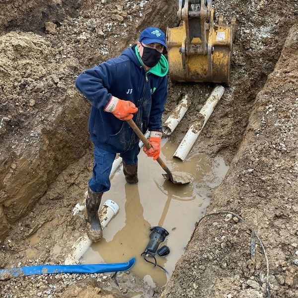 Man Installing New Drainage — St. Louis, MO — Shamrock Sewer & Drain