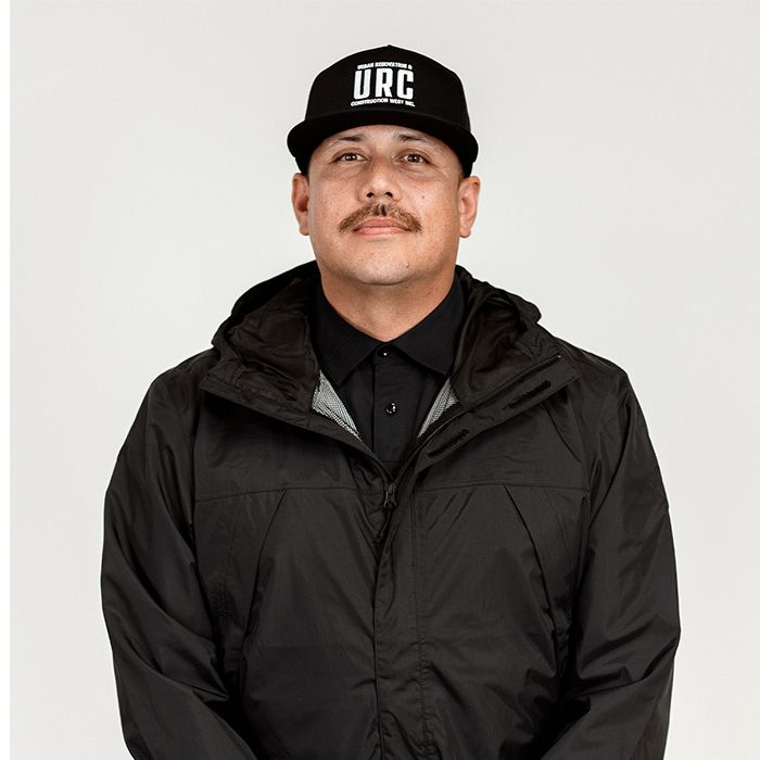 A man wearing a hat that says urc on it