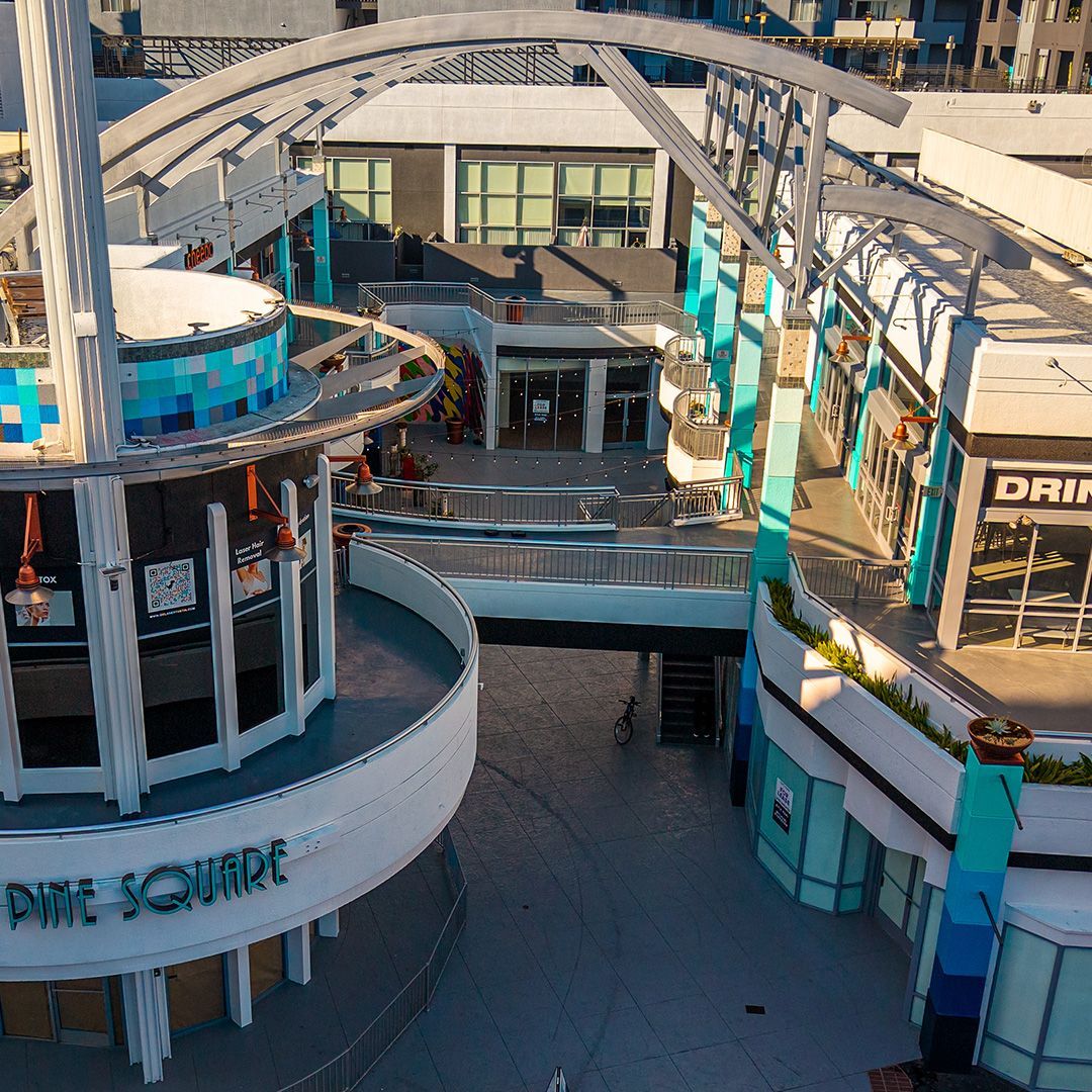 A hotel room with two beds and a desk.