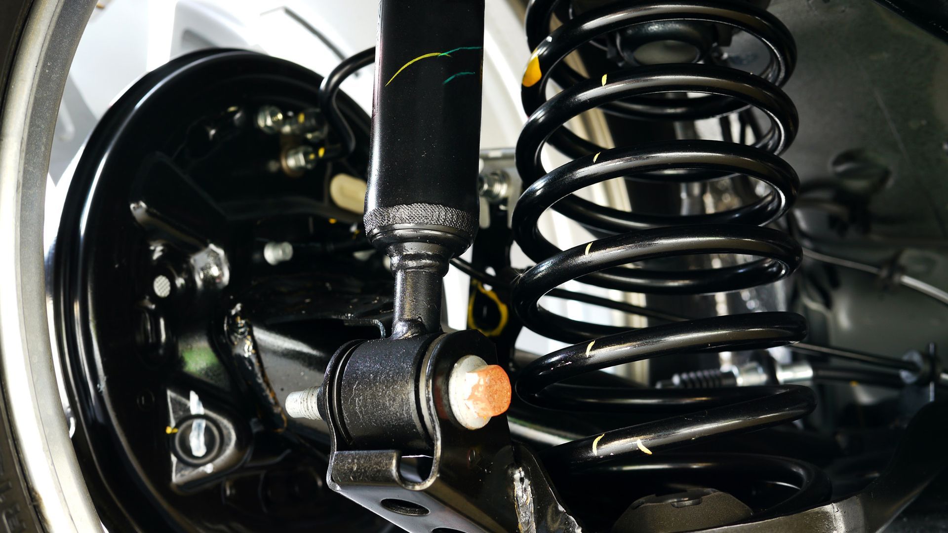 A close up of a shock absorber on a car.