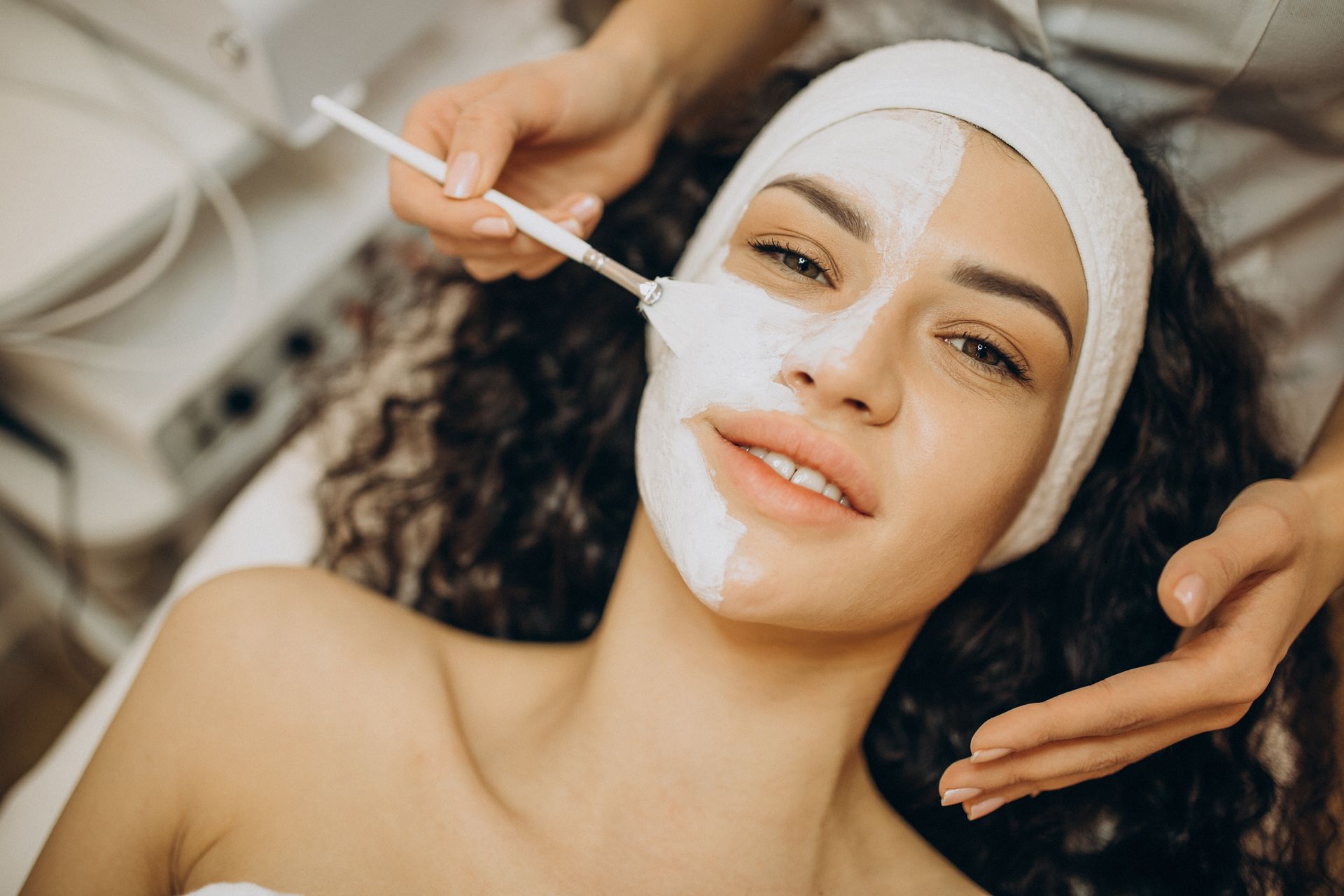 A woman is getting a facial treatment at a spa.