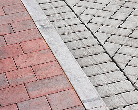 there are two different types of bricks on the sidewalk .