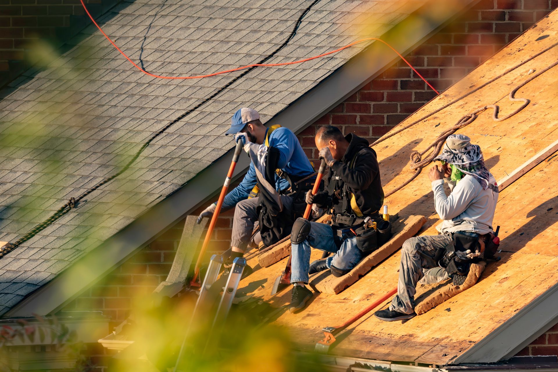 Multifamily dwelling roof replacement with a shallow depth of field.