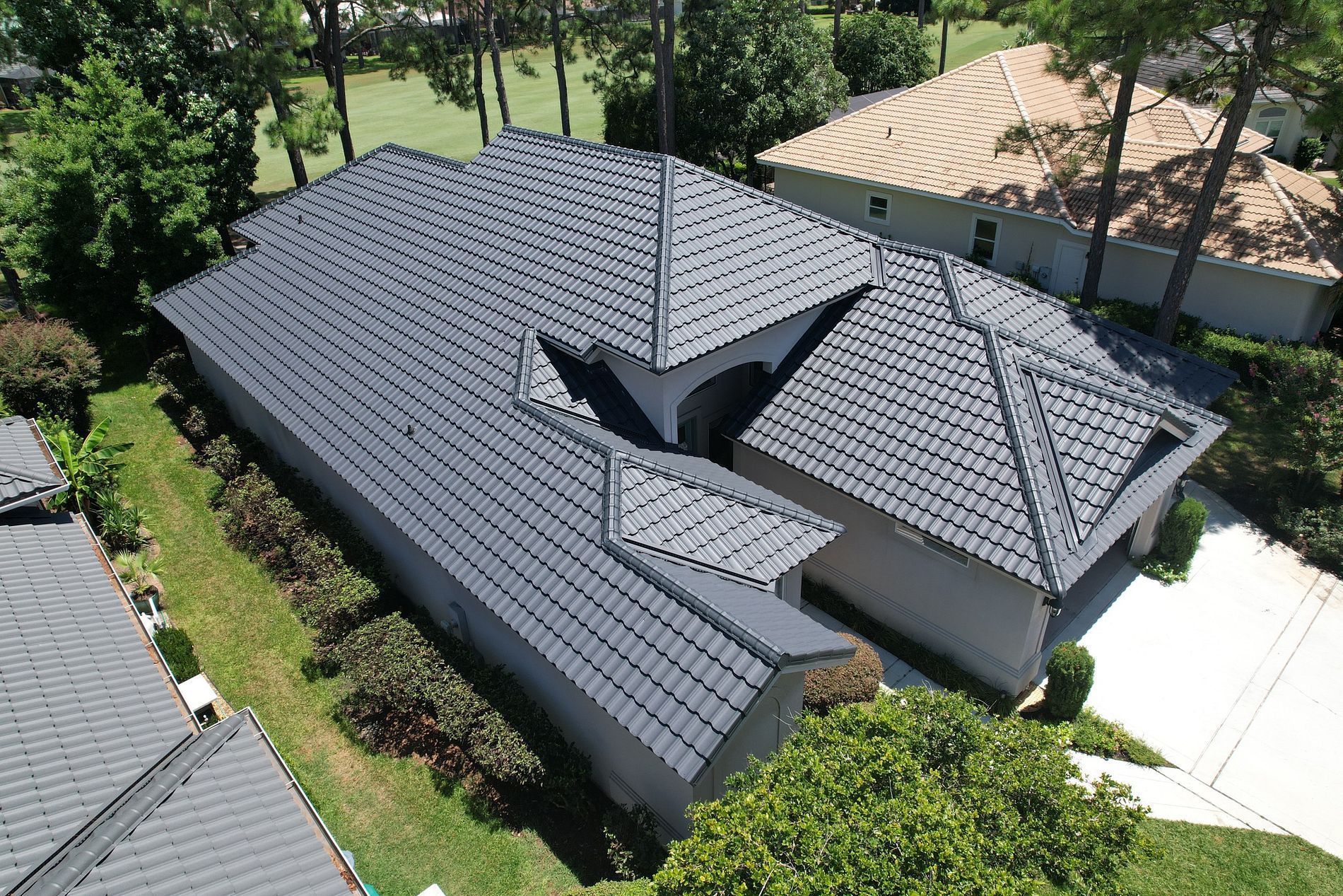 Person installing terracotta roof tiles.