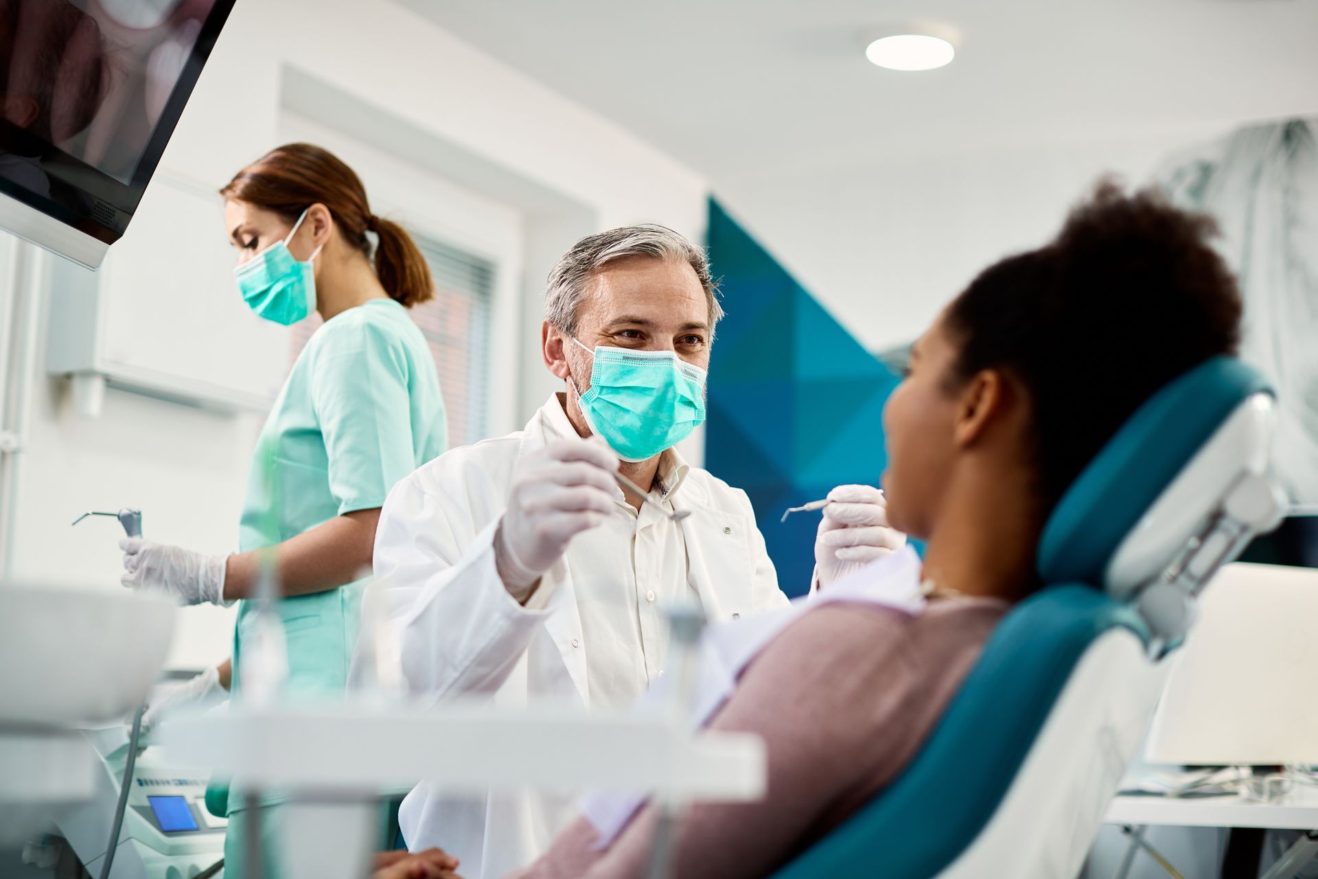 A dentist is working on a patient.