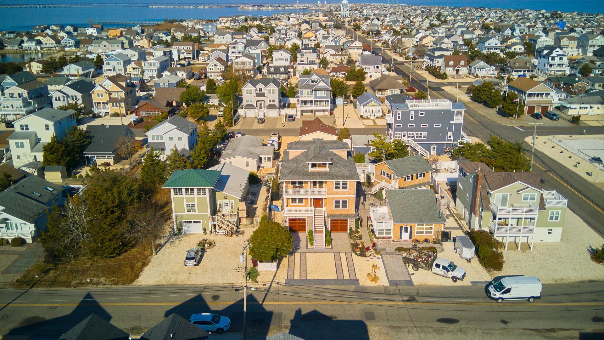 Aerial view of densely packed beach houses on a sunny day.