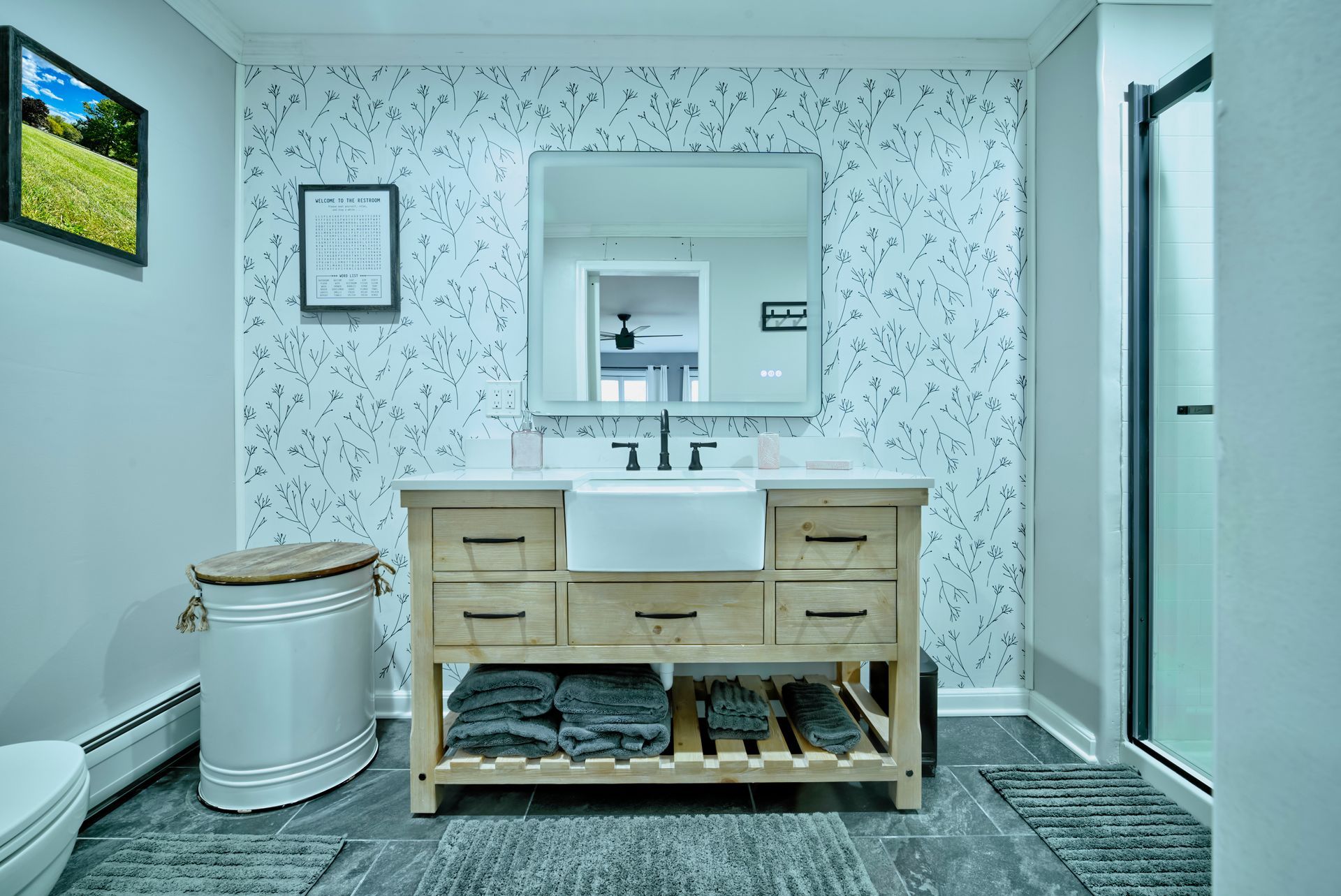 A bathroom with a sink , toilet , and mirror.