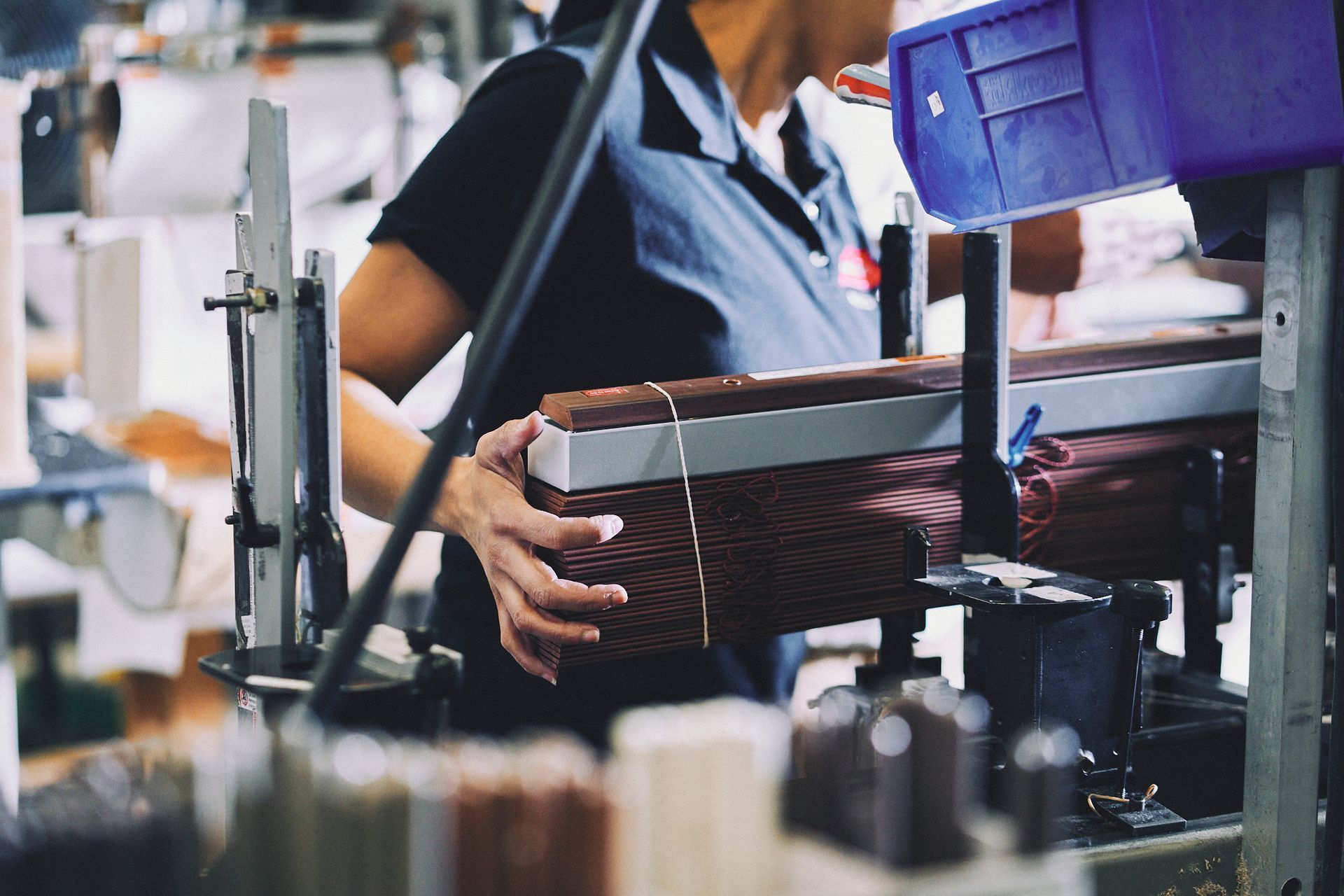 A woman is working on a machine in a factory.
