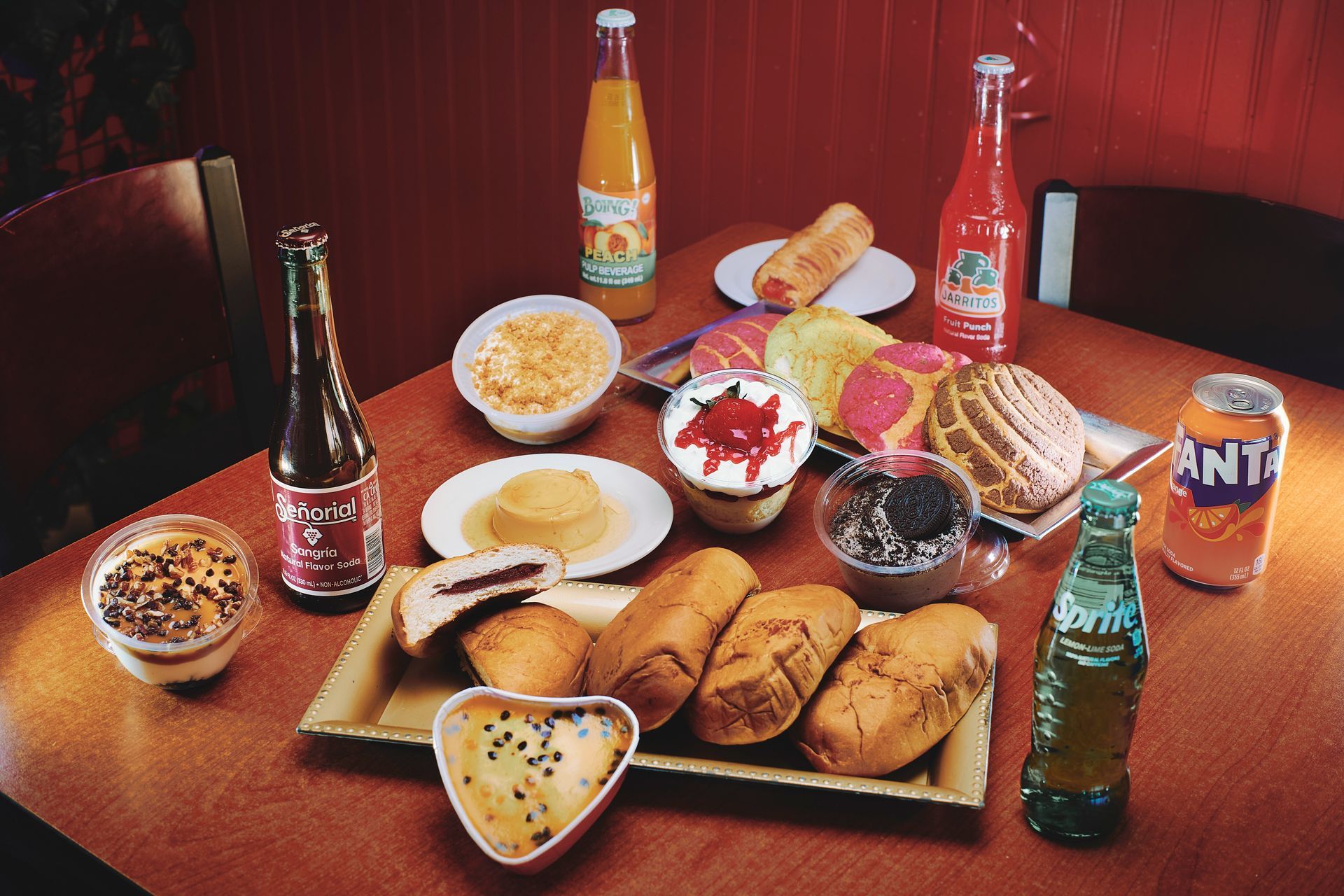 Table of Thai food: noodles, rice, shrimp, drinks, and desserts.