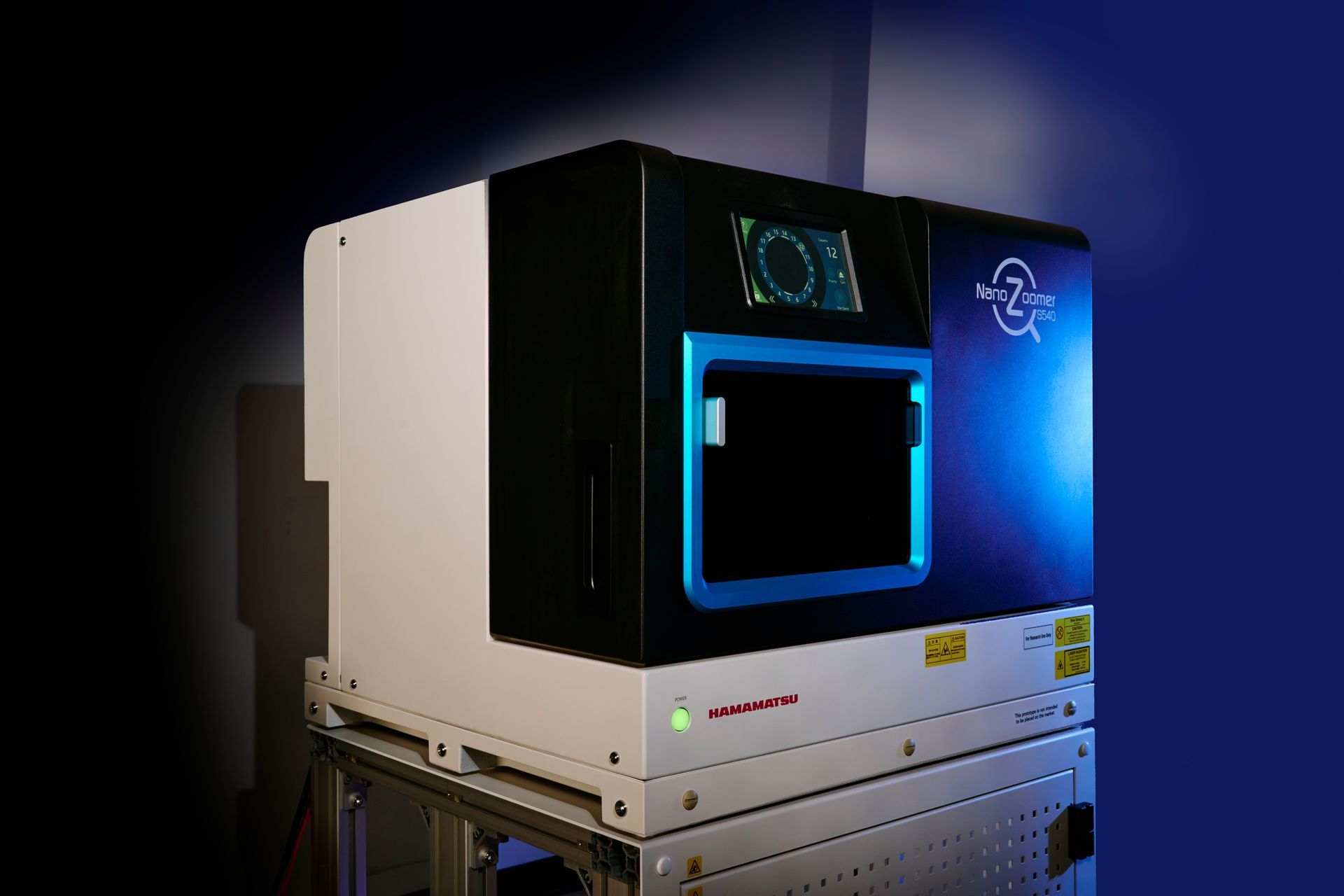 Laser marking machine, white and black casing, blue accents, illuminated blue light, set against a blue background.