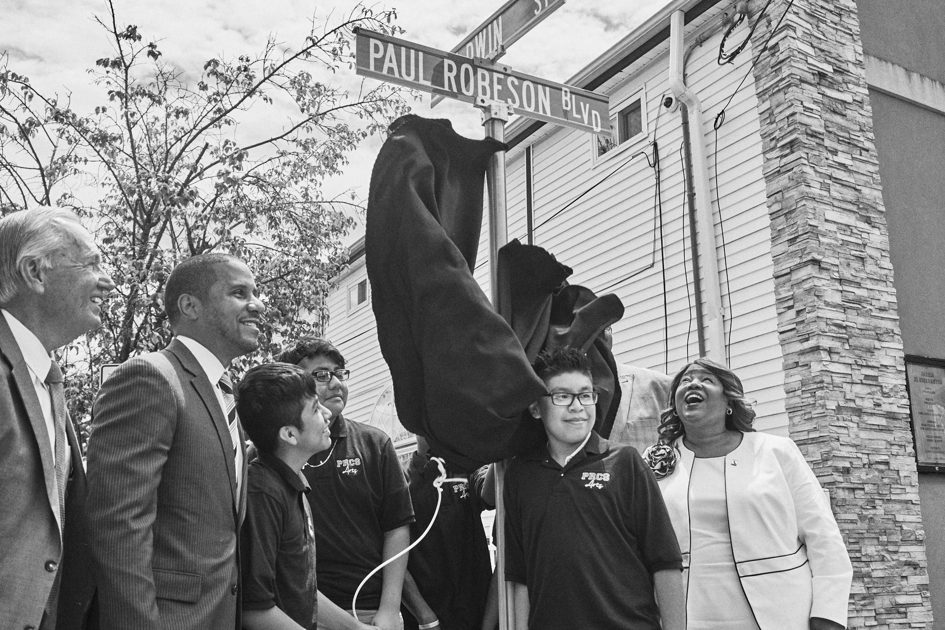 Mayor Cahill and other members of local government and education unveil the street sign.