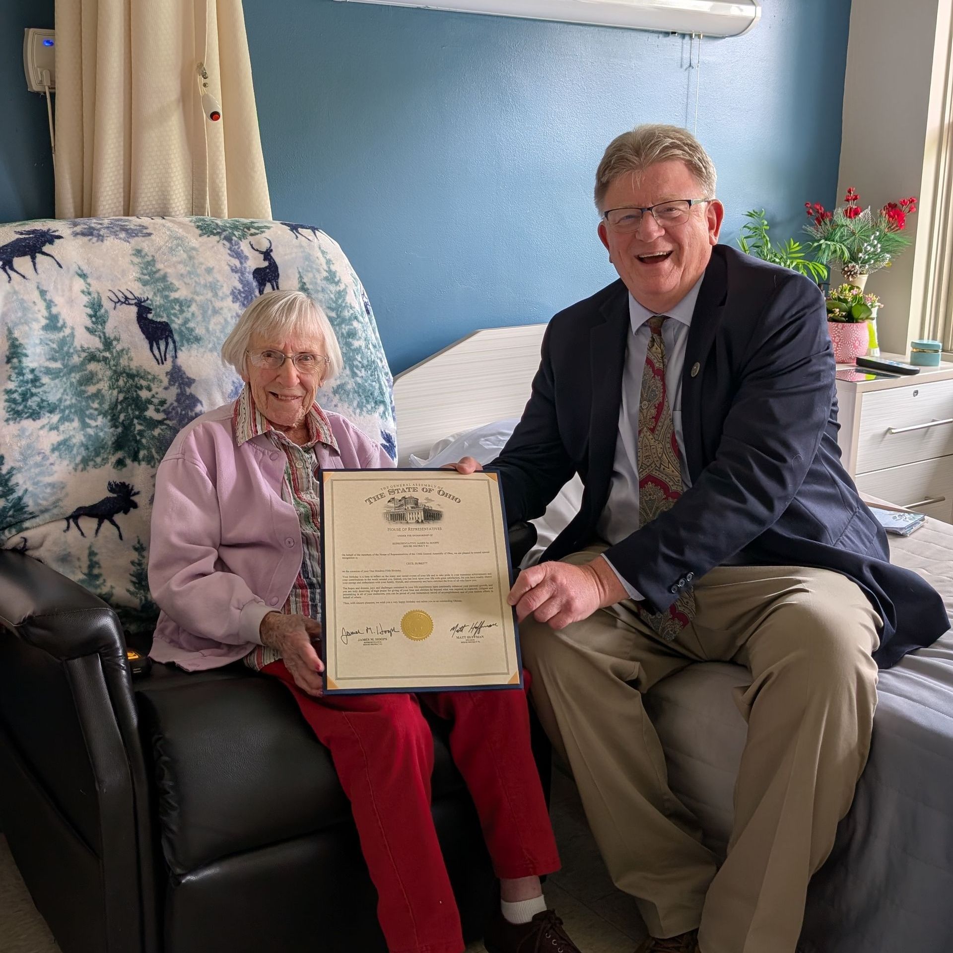 Jim Hoops presenting proclamation to woman celebrating 100th birthday