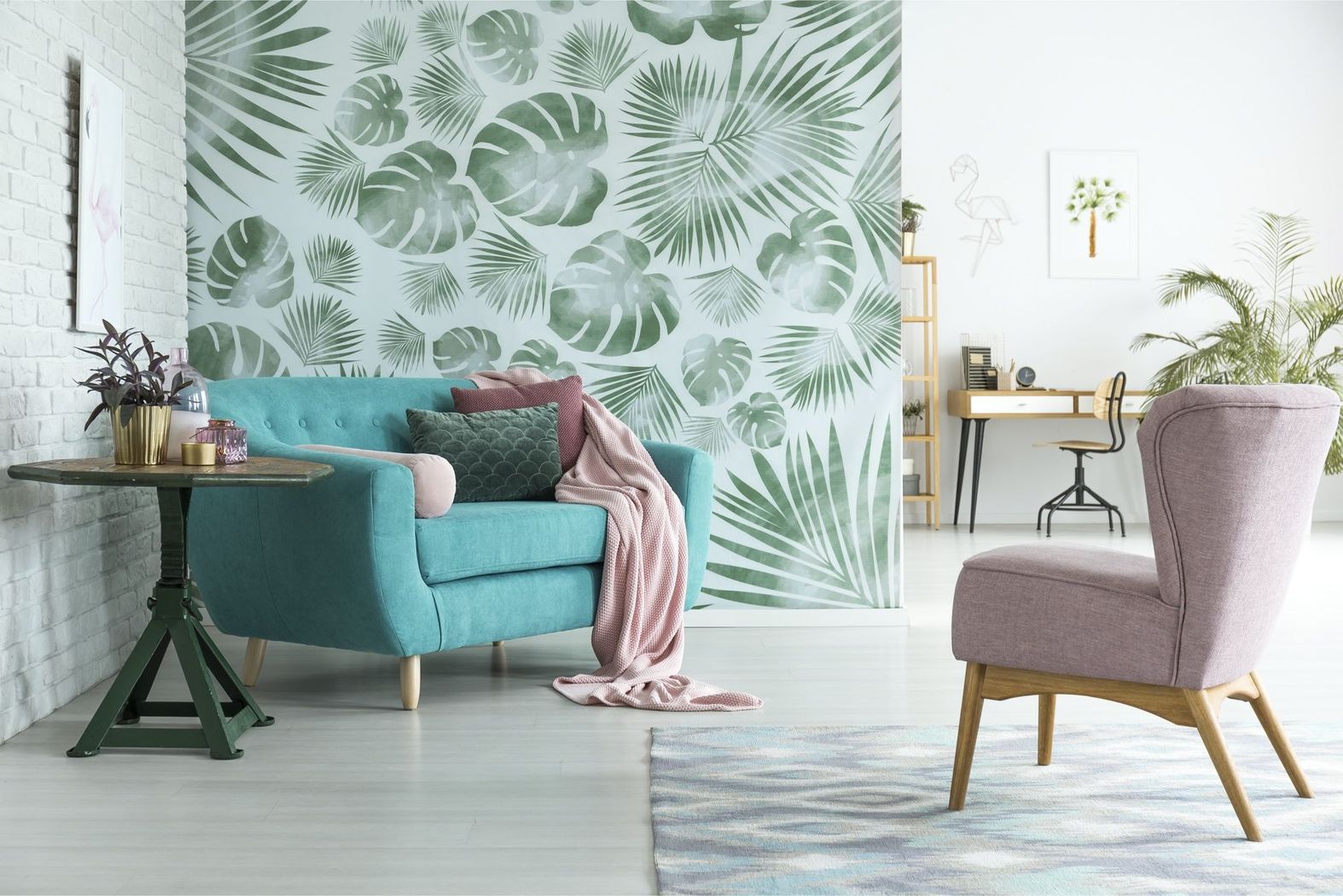 A living room with a blue couch and a pink chair.