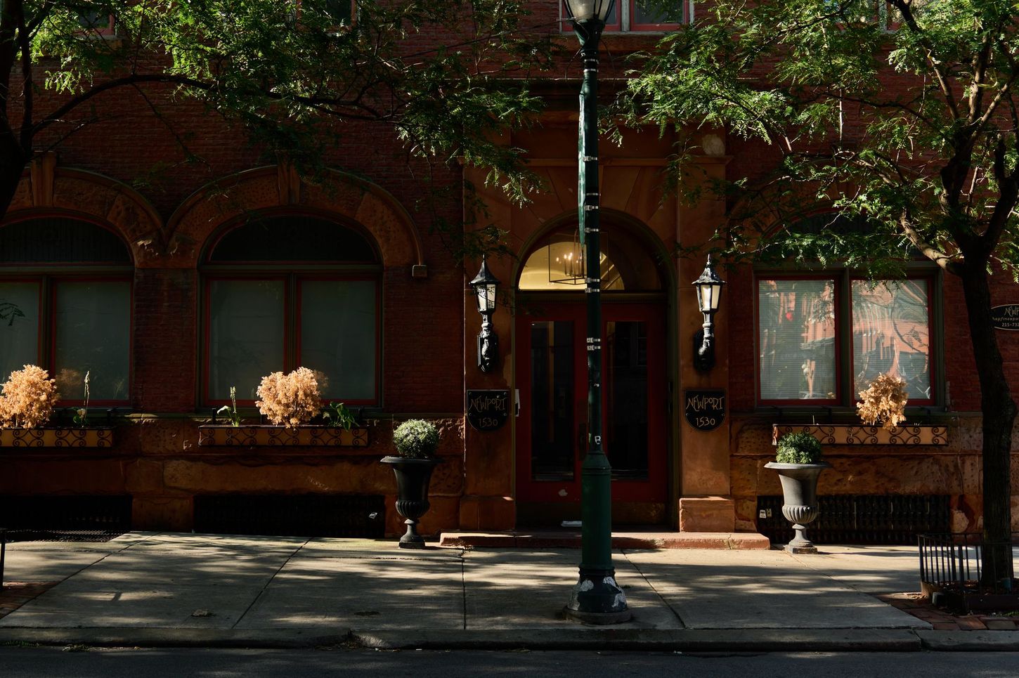 A brick building with a street light in front of it