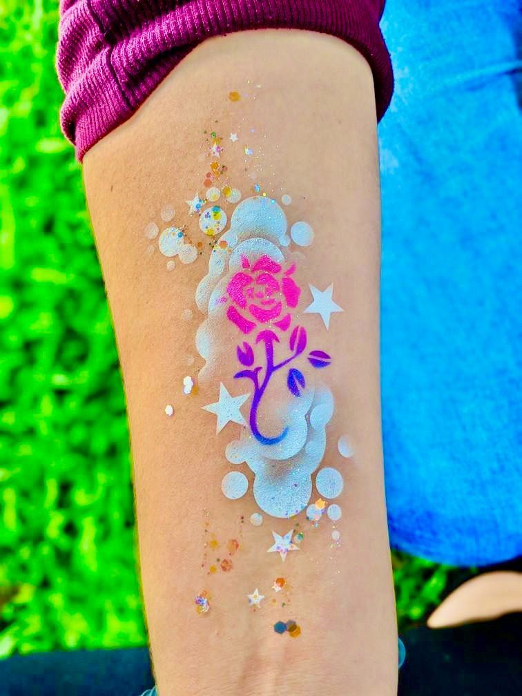 A person has a tattoo of a rose on their arm.