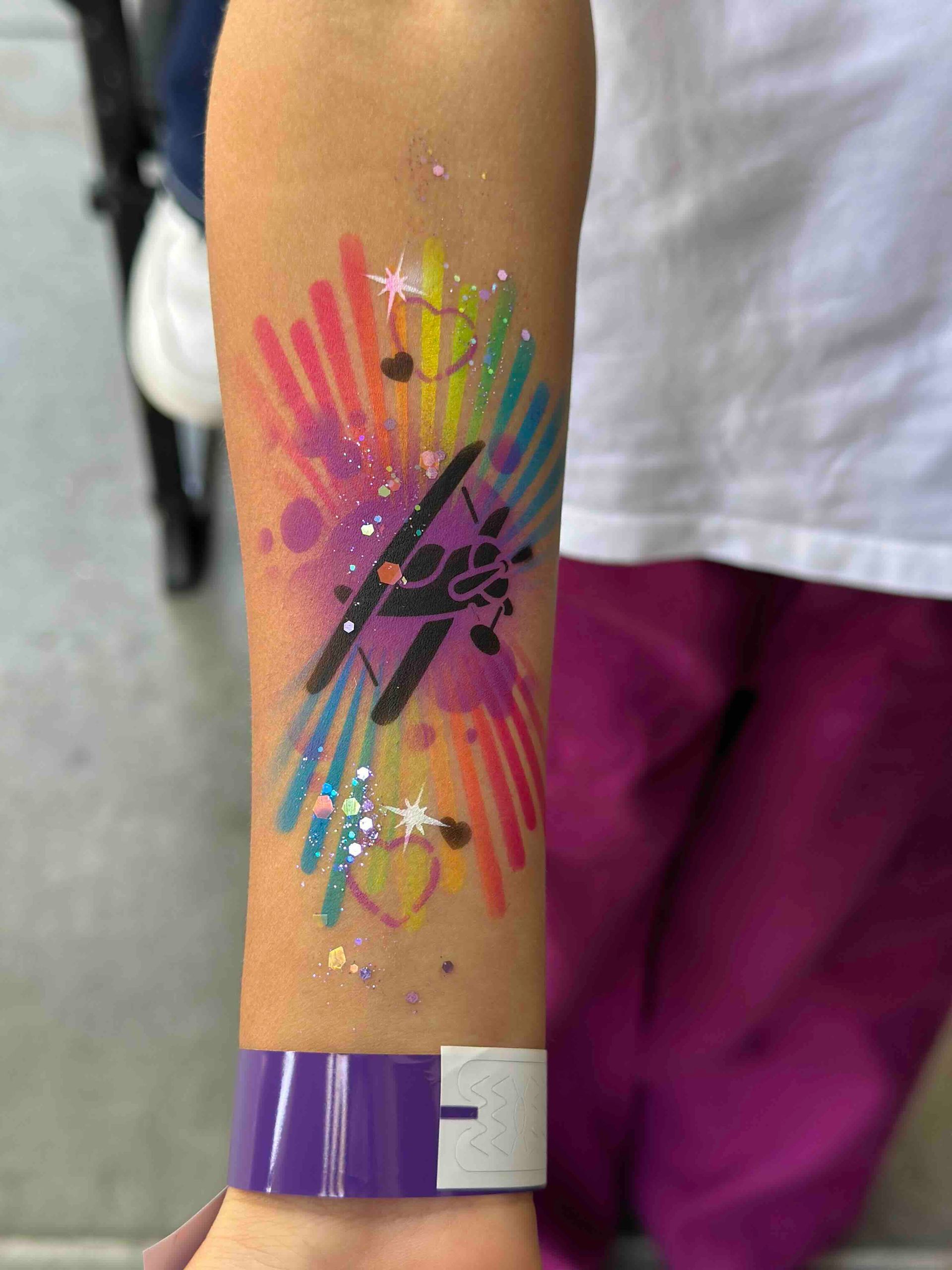 A person with a colorful tattoo on their arm.