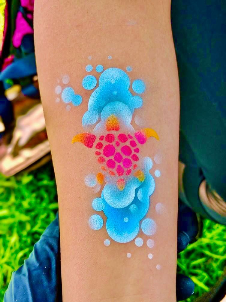 A person has a turtle painted on their arm.