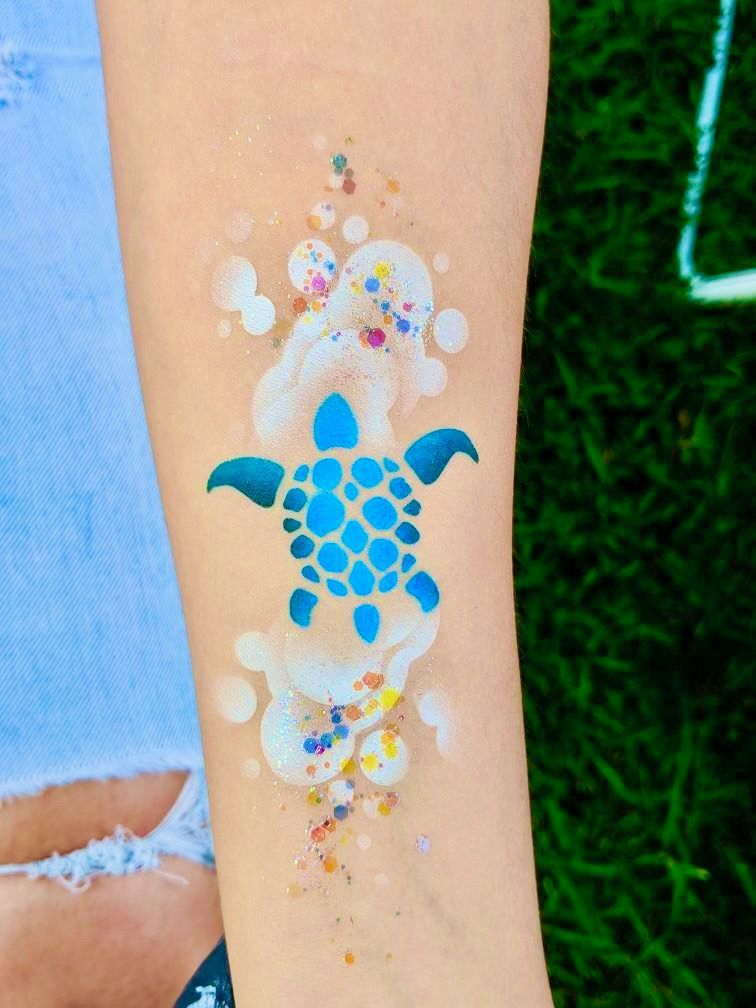 A person has a tattoo of a turtle on their arm.