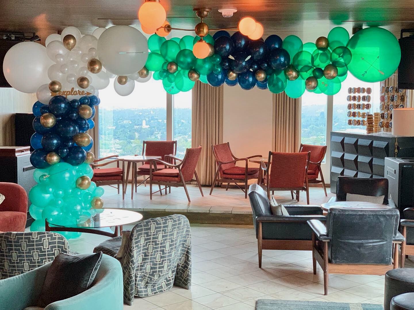 A living room filled with furniture and balloons.