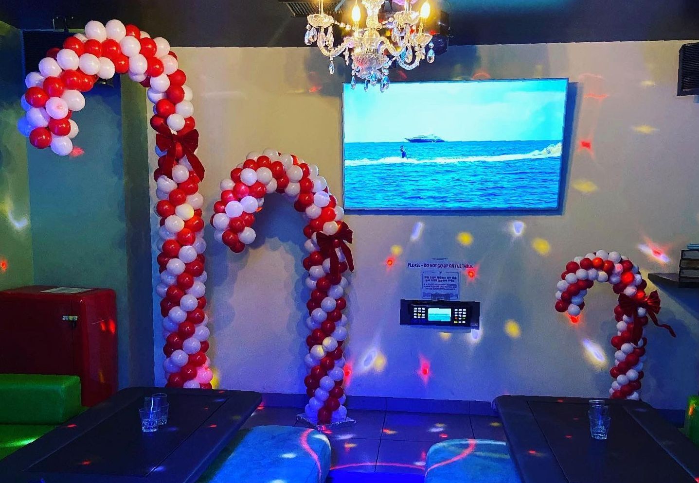 A room decorated with red and white balloons in the shape of candy canes.