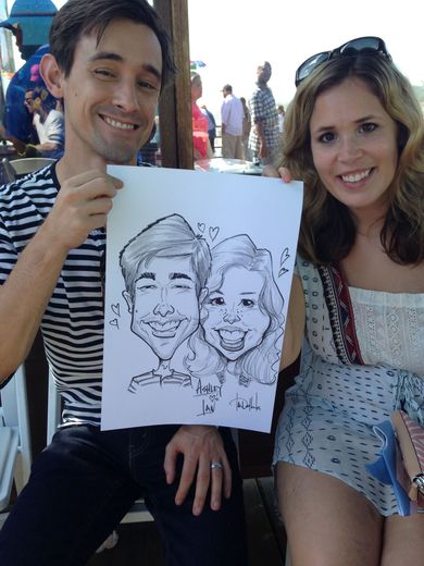 A man is holding up a caricature of him and a woman