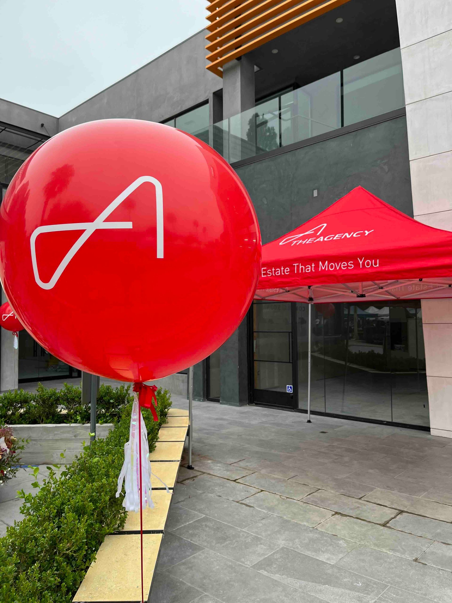 A large red balloon with the letter a on it. Company branded balloons. custom balloons for business.