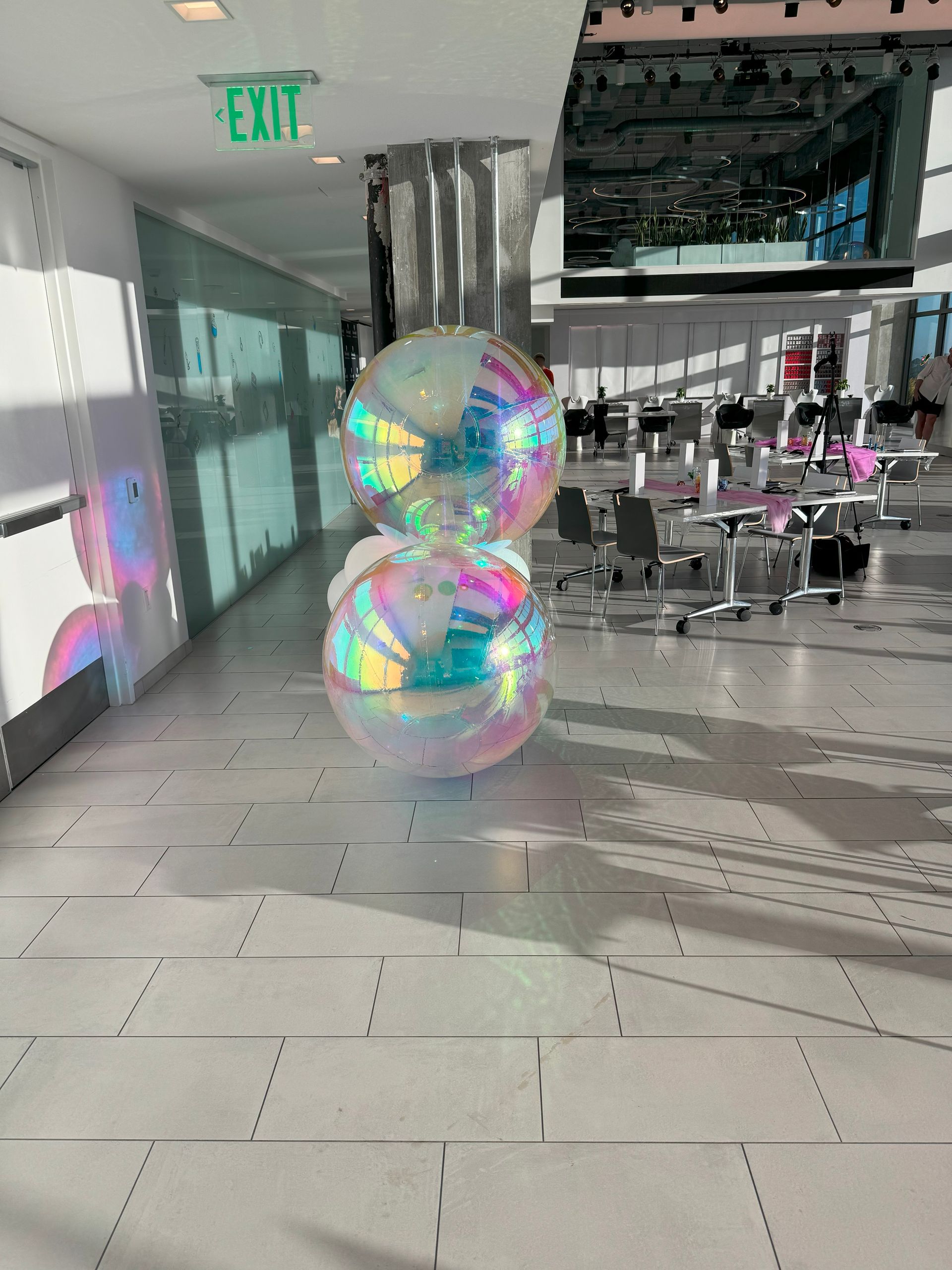 A hallway with a green exit sign on the ceiling