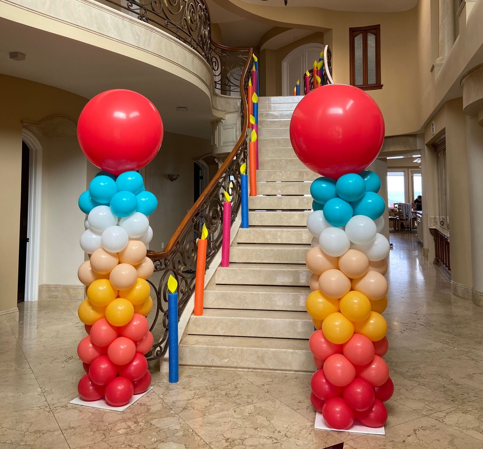 A staircase is decorated with balloons and candles