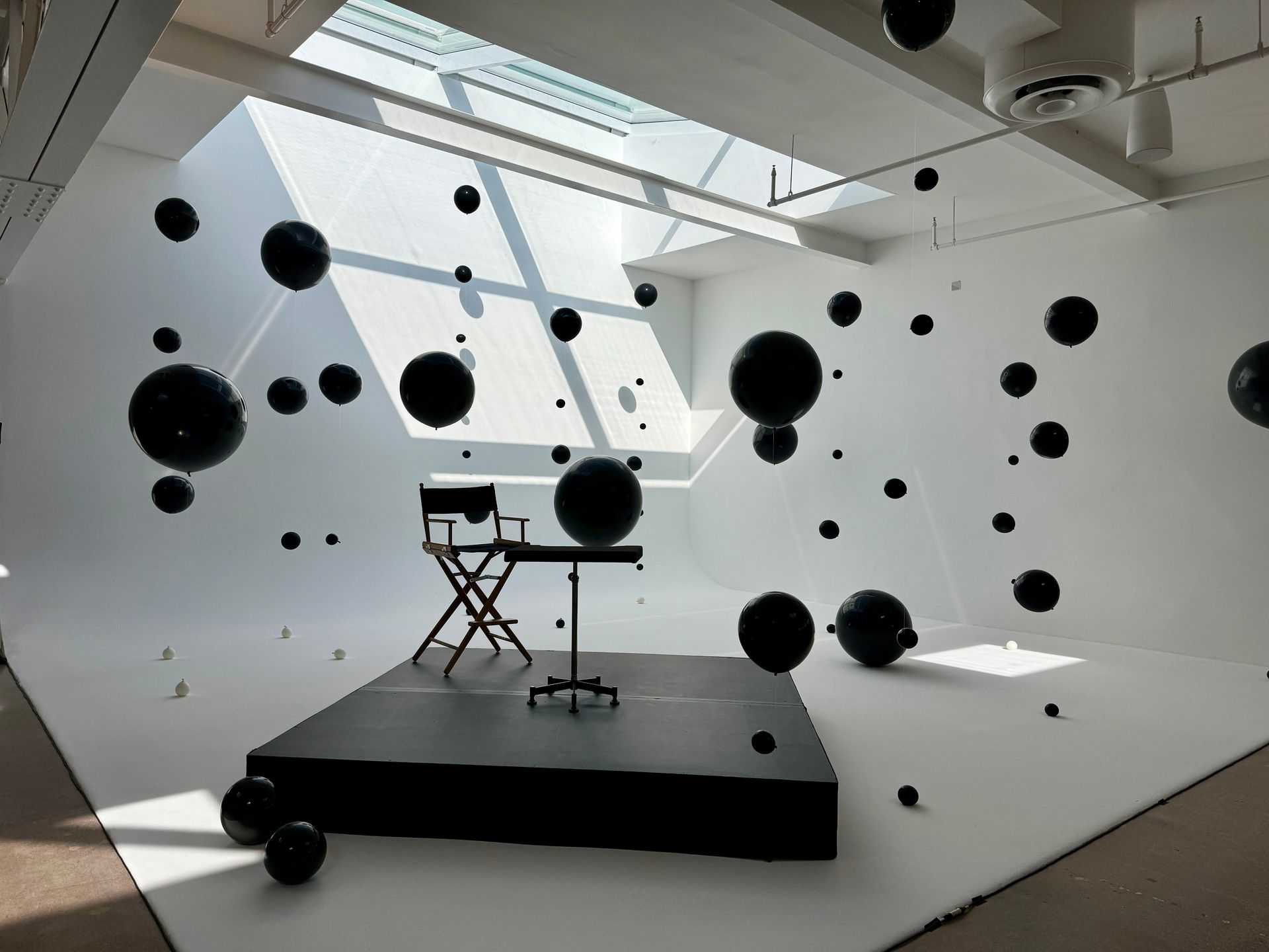 A room with black balls floating in the air