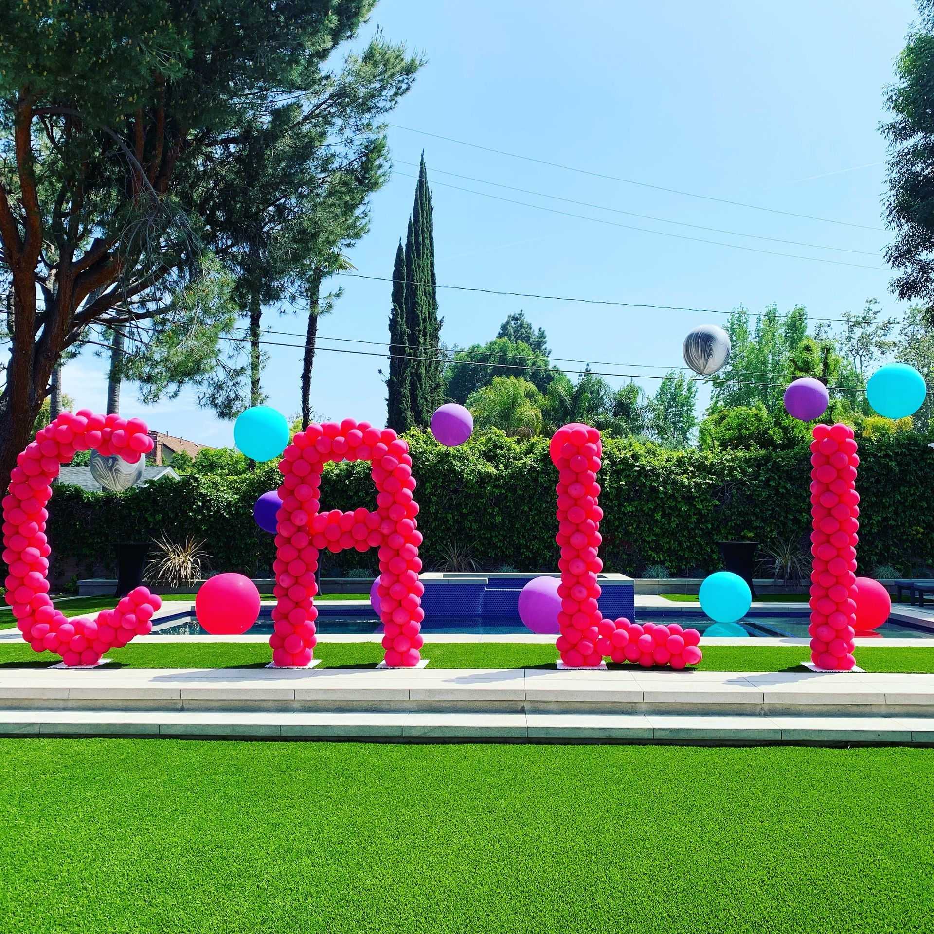 The word calli is made out of pink balloons