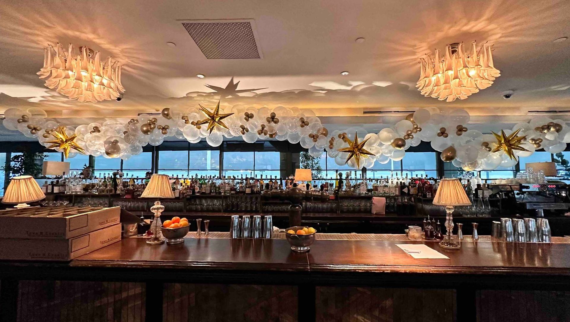 A bar with balloons and stars hanging from the ceiling.